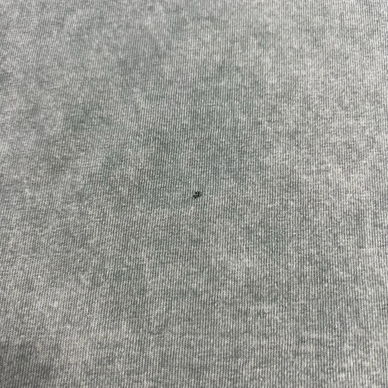 Close-up of Five Star Silver heavyweight grey garment-dyed cotton t-shirt fabric with a small dark speck detail.